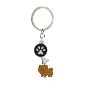 Detail of metal dog keychain with Chow Chow charm, bone pendant and black paw print tag