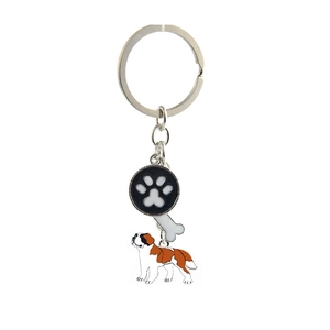 Detail of pet keychain with Saint Bernard charm, black paw print, and white bone pendant