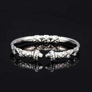 Detailed macro view of vintage silver cuff bracelet with intricate embossed floral carvings