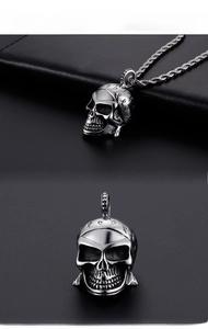 Macro detail of retro punk skull pendant with mysterious carvings on stainless steel chain