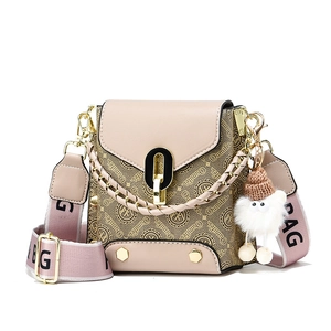 Chic beige crossbody bag with logo pattern, wide pink strap and cute teddy bear pendant