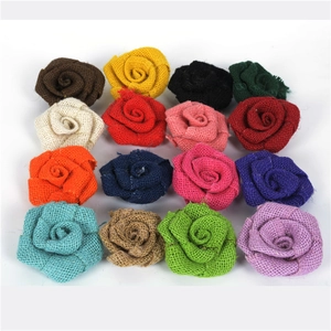 Flat lay of sixteen colorful handmade burlap rose flowers in a minimalist grid arrangement