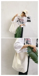 Close-up of minimalist white cotton linen tote bag with slender shoulder strap
