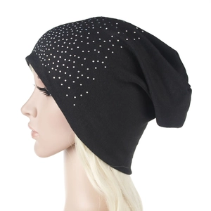 Detail of black knitted beanie with sparkling silver rhinestones and warm thermal fabric