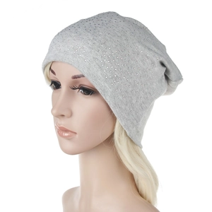 Detail of grey knitted beanie featuring sparkling rhinestone embellishments for winter