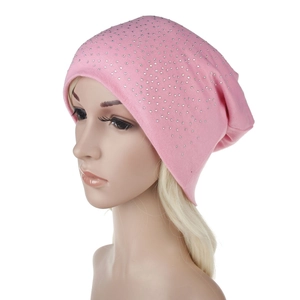Close-up of pink knit beanie featuring delicate rhinestone accents and soft texture
