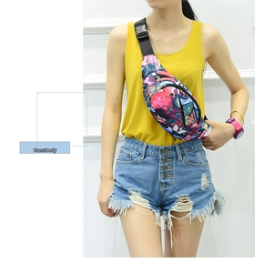 Close-up of colorful graffiti print waist bag with adjustable black strap and buckle