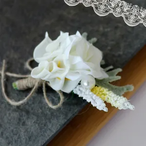 White calla lily and rose boutonniere with pearl detail and rustic twine handle