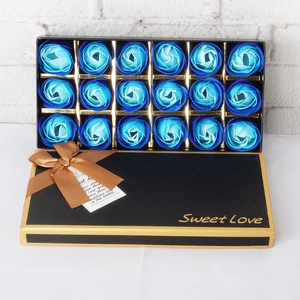 Detail view of a black gift box featuring 18 blue gradient soap roses and gold lettering