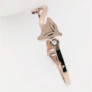 Elegant 18K rose gold fox head open bangle featuring sandblasted finish and crystal accent