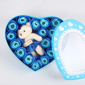 Blue heart-shaped soap rose gift box featuring a plush bear and festive floral detail