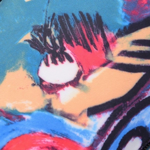 Close-up of durable fabric showing a colorful abstract graffiti pattern on a sports bag