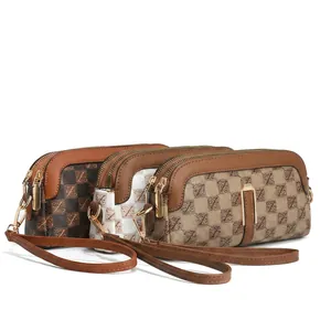 Detail view of retro mini crossbody bags in check and floral patterns with metal zippers
