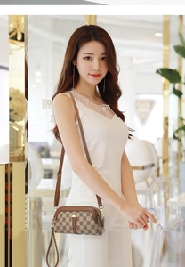 Close-up of brown monogram mini crossbody bag with gold zippers and adjustable shoulder strap