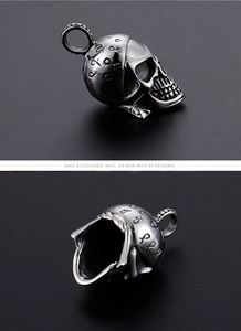 Macro shot of silver titanium steel skull pendant with intricate vintage carvings