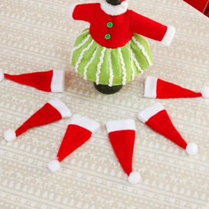 Festive Christmas wine bottle cover set with mini red Santa hats and holiday skirt decor