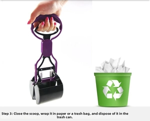Detail of purple pet pooper scooper showing handle operation to release waste into bin