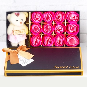 Detail of pink soap roses and a plush bear in a black Sweet Love gift box