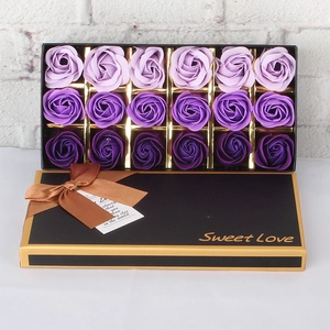 Detail of 18 purple gradient soap rose flowers in a black luxury gift box with golden trim