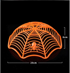 Macro detail of an orange spider web fruit basket for Halloween party snack decoration
