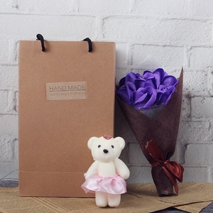 Detail of soap rose bouquet with plush teddy bear in kraft paper gift bag packaging