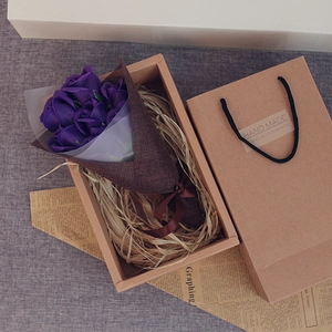 Detailed view of 7 purple soap roses in a rustic kraft gift box with matching carry bag