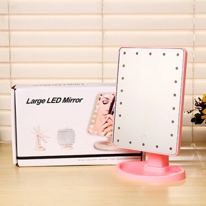 Pink desktop LED makeup mirror with 360 rotation and integrated storage base