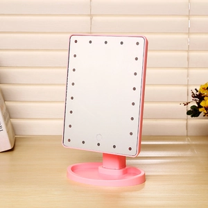 Pink LED makeup mirror detail showing the base storage tray and integrated light beads
