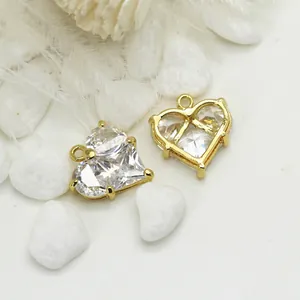 14K gold plated heart charms with zircon crystals on a minimalist background
