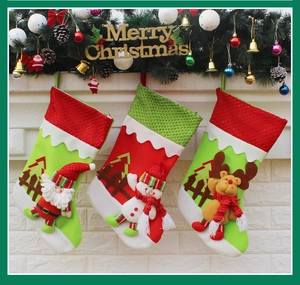 Three festive Christmas stockings featuring Santa, Snowman, and Reindeer hanging on a fireplace