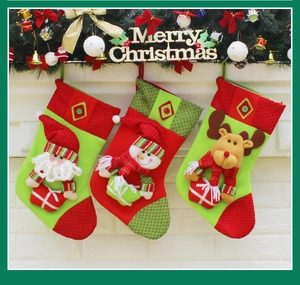 Detailed view of three Christmas stockings with 3D Santa, Snowman and Reindeer characters