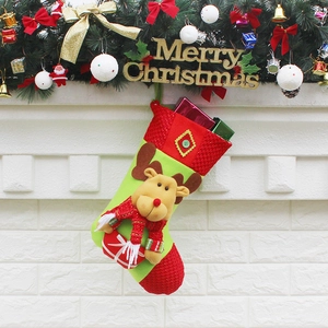 Christmas stocking with 3D reindeer and gift box detail hung by a festive fireplace