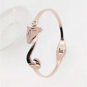 Detail of rose gold swan bangle with sandblasted texture and sparkling rhinestone inlay