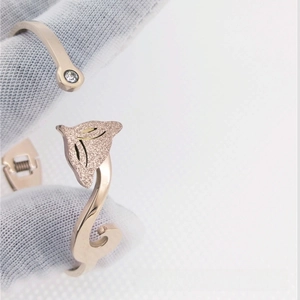 Detail of rose gold fox bangle with frosted finish and clear zircon inlay on the end