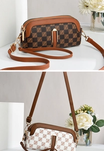 Detail of brown and white checkered crossbody phone bags with double gold zipper closure