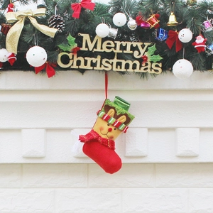 Festive Christmas stocking with reindeer design hanging on a decorated fireplace mantle