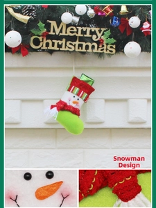 Detail of a Christmas snowman stocking showing knit texture and 3D plush carrot nose
