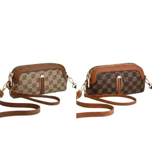 Close-up of small crossbody phone bag with checkered pattern and gold metal lock detail