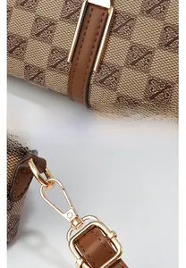 Detail of crossbody bag featuring golden hardware, letter print canvas and brown leather trim