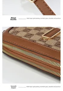 Close-up of golden metal clasp and smooth zipper on brown patterned crossbody bag