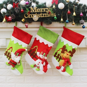 Three Christmas stockings with Santa, Snowman, and Reindeer hanging on a fireplace