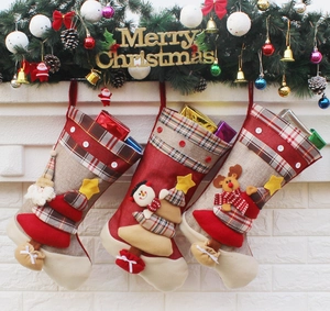 Detailed view of burlap Christmas stockings with 3D Santa, Snowman, and Reindeer motifs