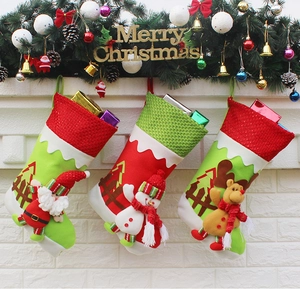Detailed view of Santa, Snowman, and Reindeer Christmas stockings hanging on a festive mantel