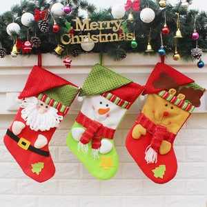 Three Christmas stockings with Santa, Snowman and Reindeer designs on a festive mantel