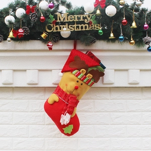 Classic red and yellow Christmas stocking with reindeer character hanging on a festive garland