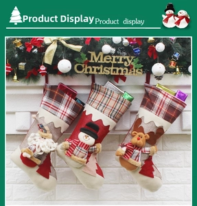 Detailed view of 3D Santa, Snowman, and Reindeer Christmas stockings hanging on a white wall