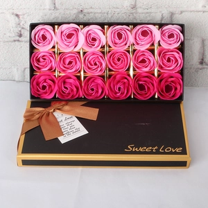 Detail of 18 gradient pink soap roses in a black gift box with a brown ribbon bow