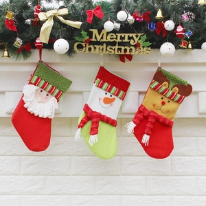 Christmas stockings set with Santa, Snowman and Reindeer hanging on a festive fireplace mantel