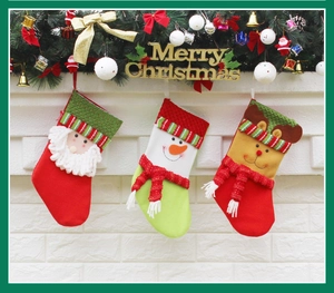 Three festive Christmas stockings featuring Santa, snowman, and reindeer on a white fireplace