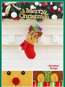 Detailed view of a red Christmas stocking with a 3D moose character and green knit cuff